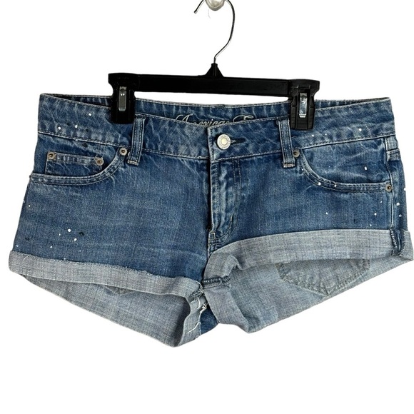 American Eagle Rolled Cuff Denim Cut Off Shorts Size 8 Tiny Paint Drops Raw Hem - Picture 1 of 9